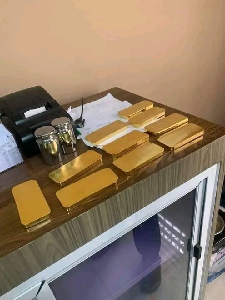 Gold bars being weighed and verified at our desk